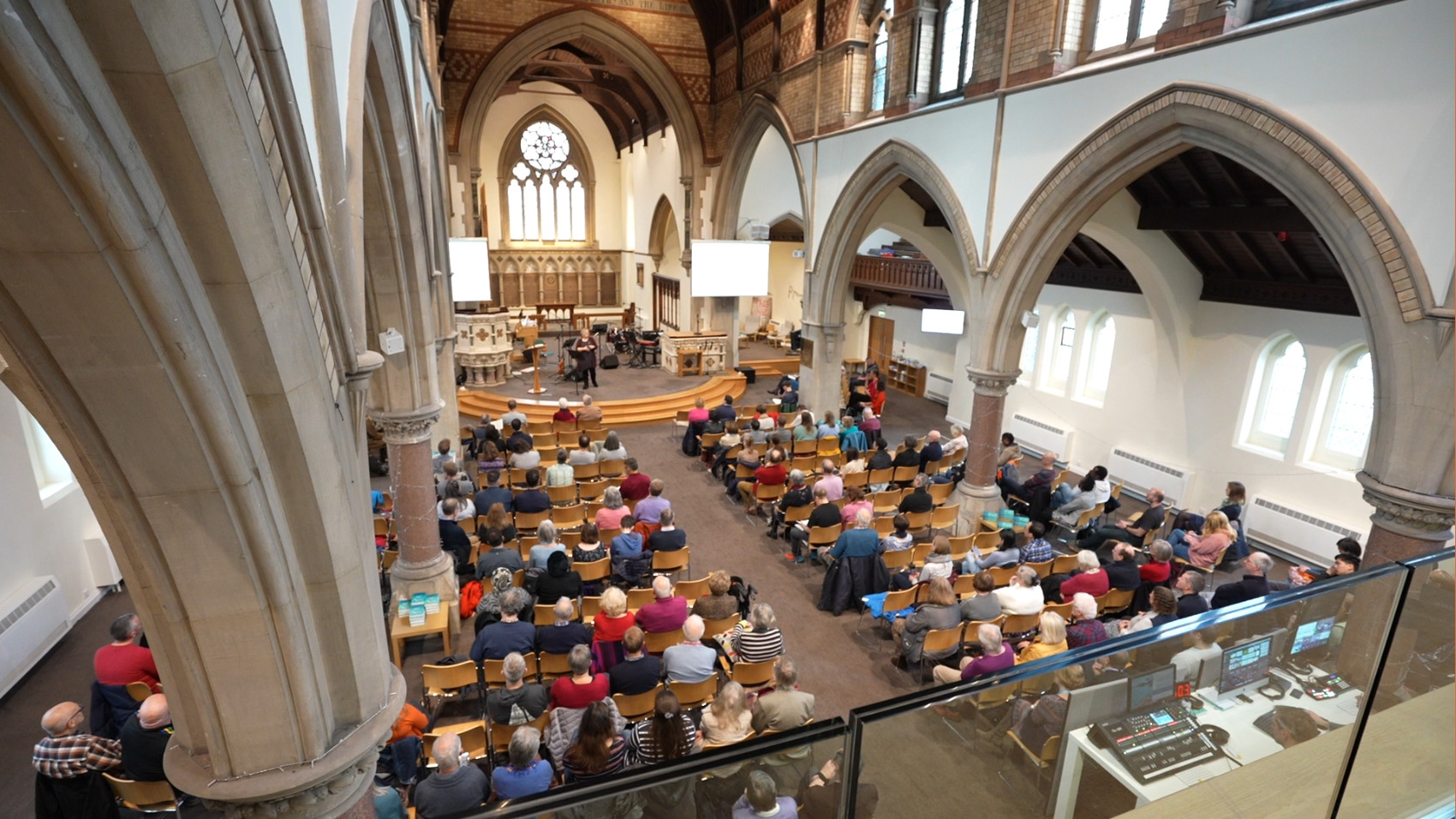 People in church watching a women talk