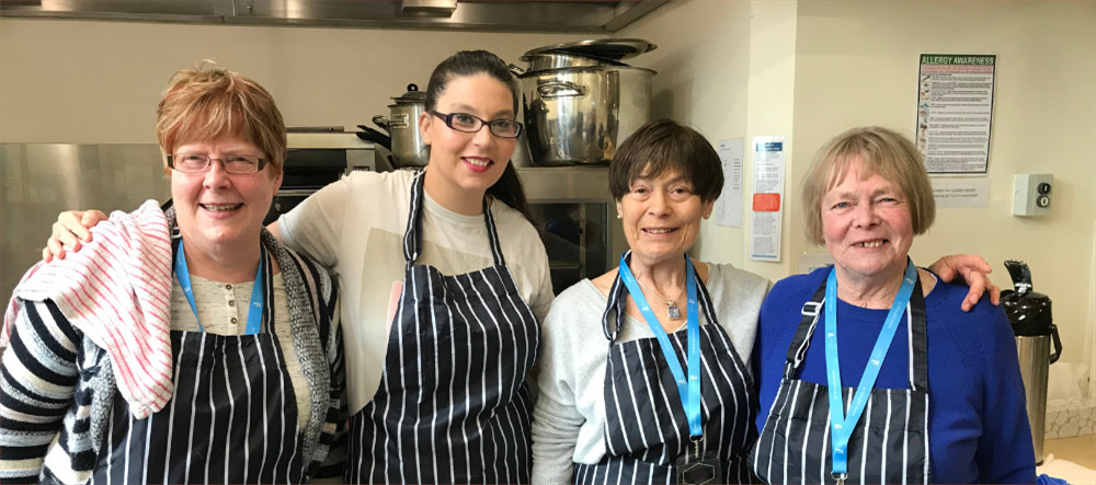 4 women with aprons on